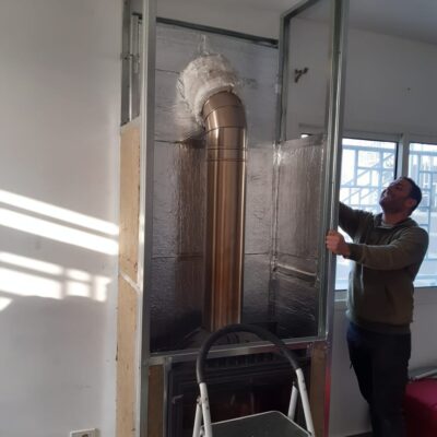 Foil backed fibreglass insulation panels affixed